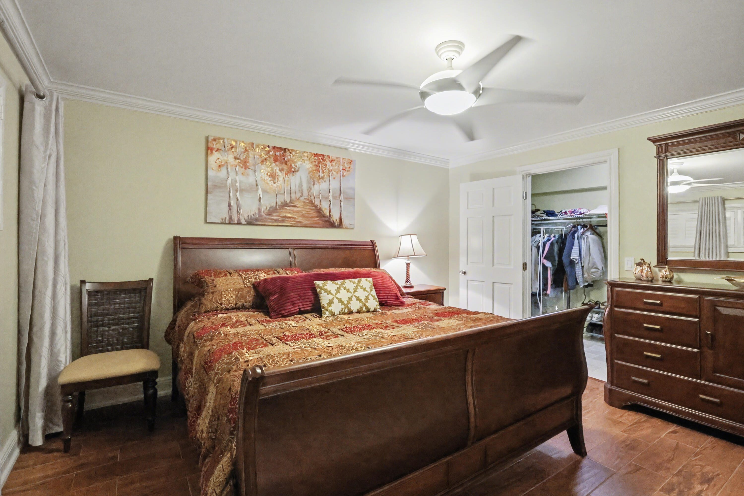 129 South Golfview Road, Unit 2 Lake Worth Beach, FL 33460 - Photo 23 of 35 a bedroom with a bed and a chandelier