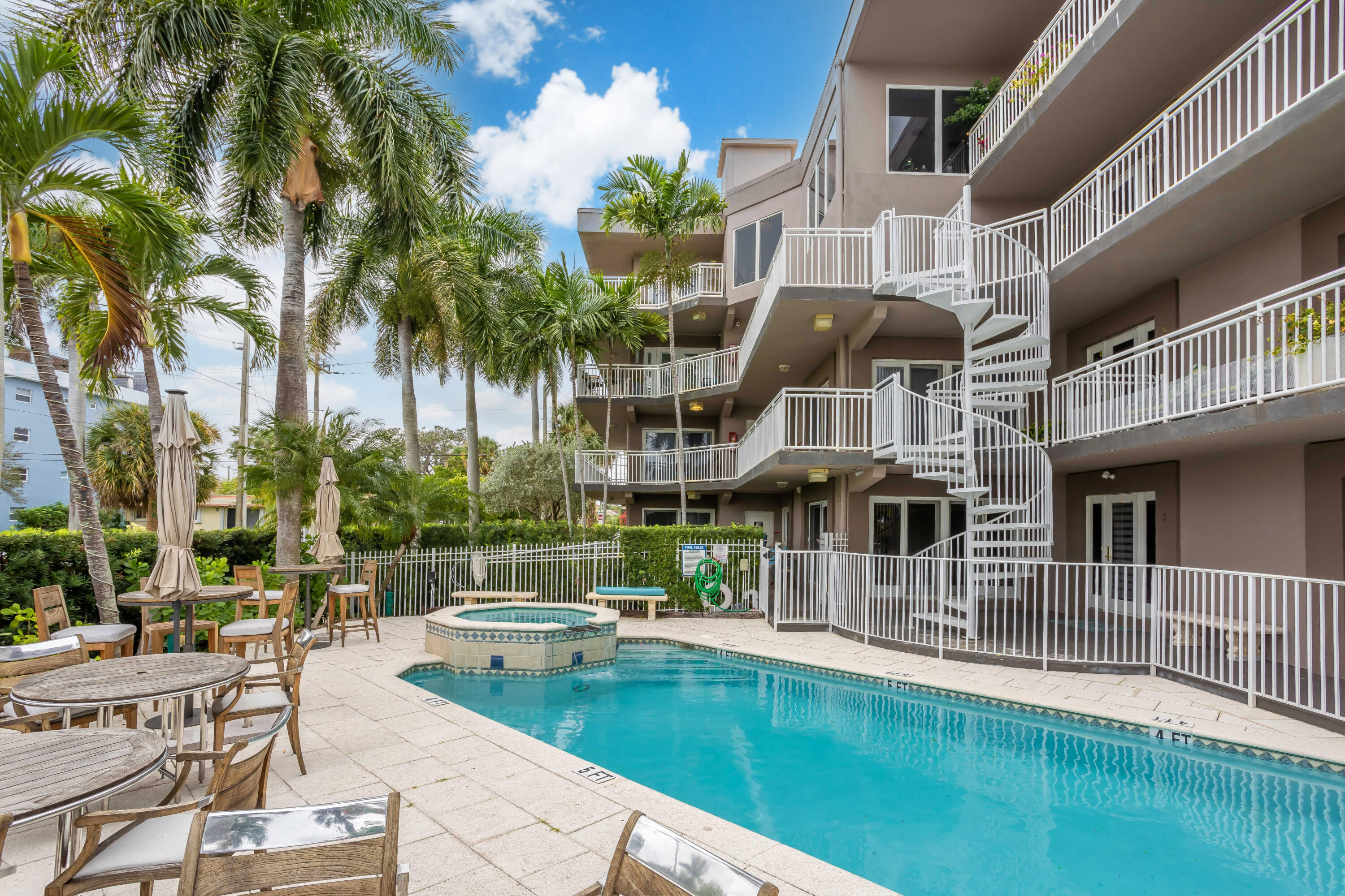 129 South Golfview Road, Unit 2 Lake Worth Beach, FL 33460 - Photo 3 of 35 a view of a house with pool and sitting area