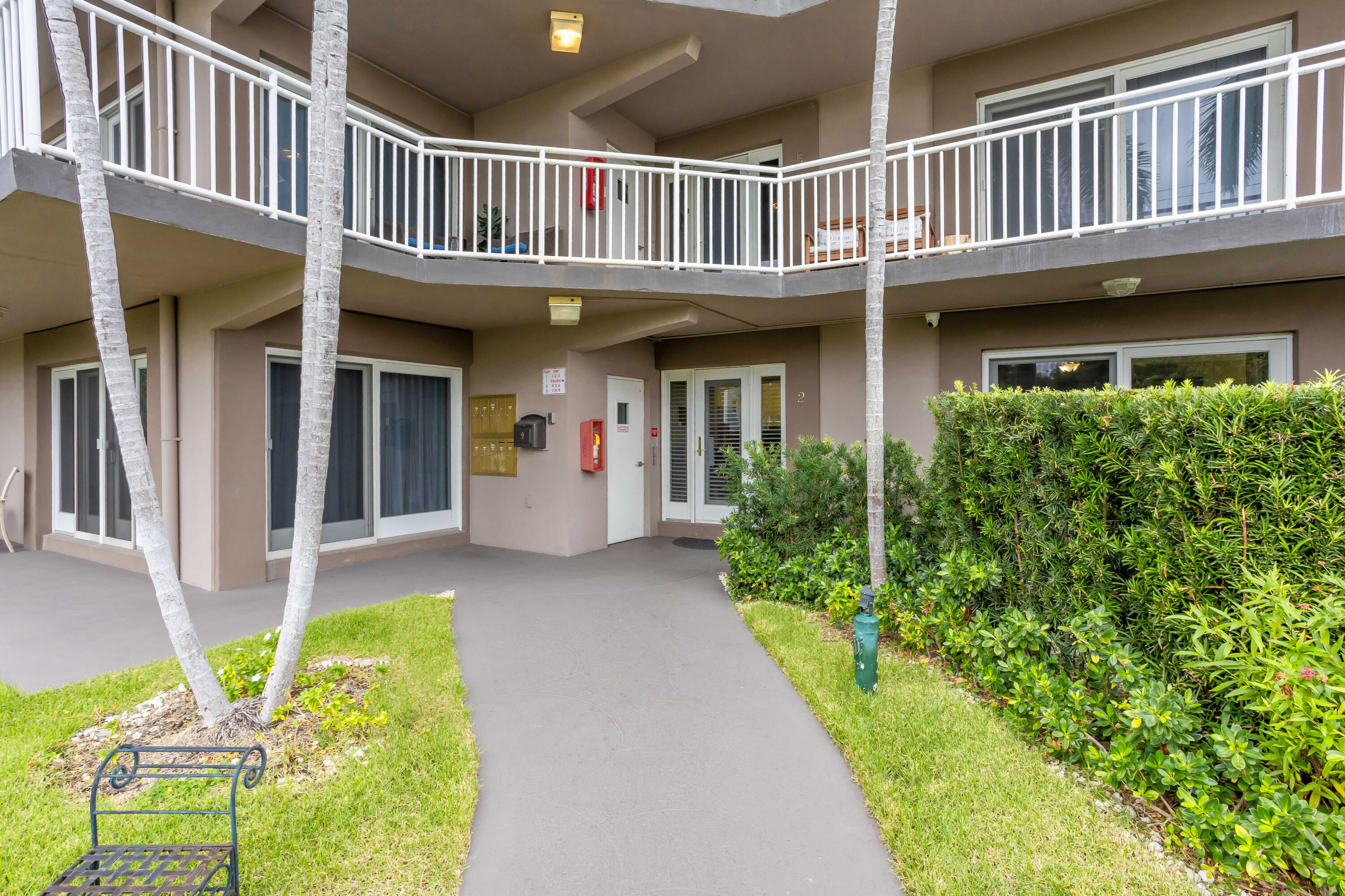 129 South Golfview Road, Unit 2 Lake Worth Beach, FL 33460 - Photo 5 of 35 a view of a house with a porch and bench