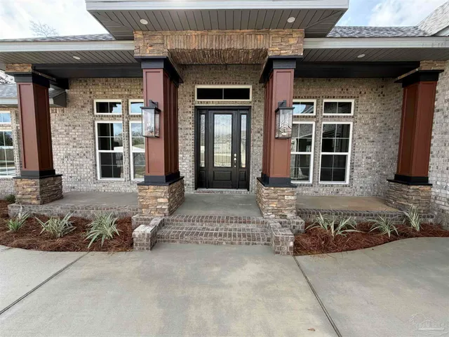 a front view of a house with glass windows