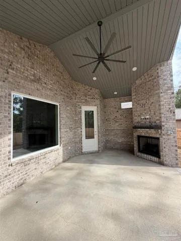 an empty room with fireplace and fan