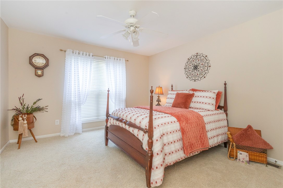 125 Inlet Pointe Drive Anderson, SC 29625 - Photo 16 of 39 Well-lit sleeping quarters with plush carpeting and a functional ceiling fan for optimal comfort.