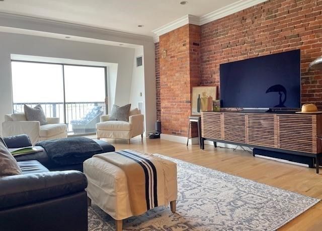 a living room with fireplace furniture and a rug
