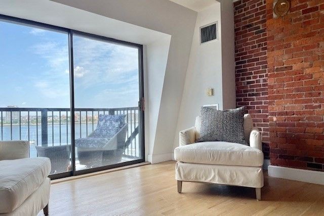 a living room with furniture and a floor to ceiling window