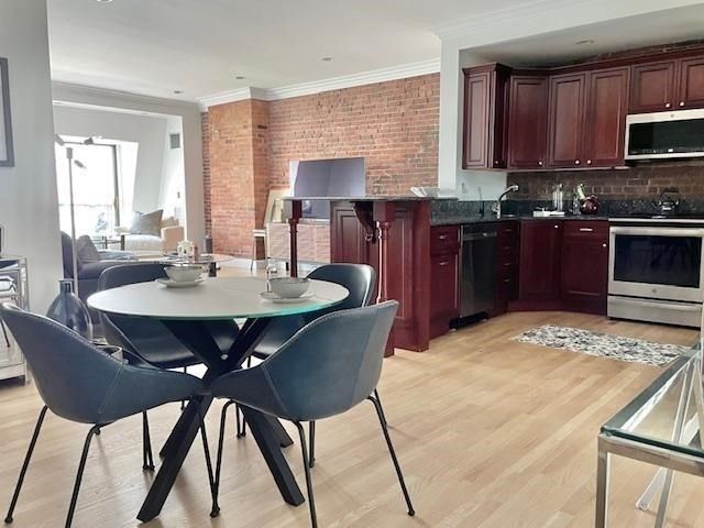 a kitchen with a dining table and chairs