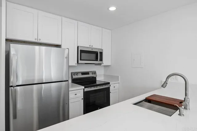 a kitchen with a refrigerator sink and microwave