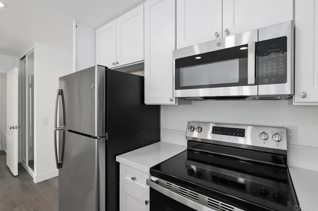 a kitchen with stainless steel appliances a refrigerator stove and microwave