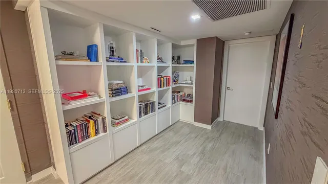 a room with a book shelf and a wooden floor