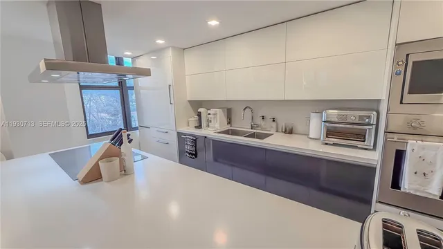 a kitchen with a refrigerator sink and cabinets