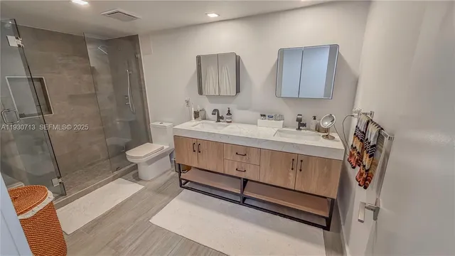 a bathroom with a sink toilet and shower