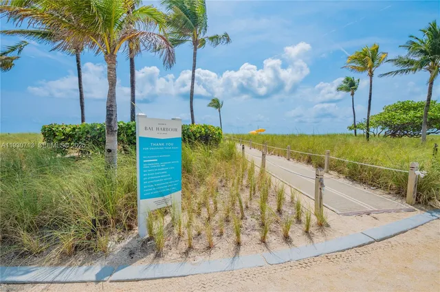 a view of a terrace with lawn chairs and wooden fence