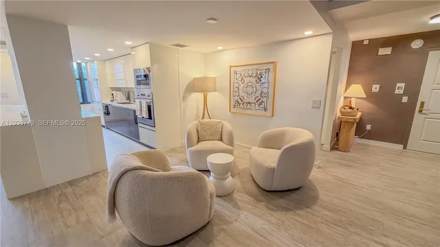 a living room with furniture and kitchen view