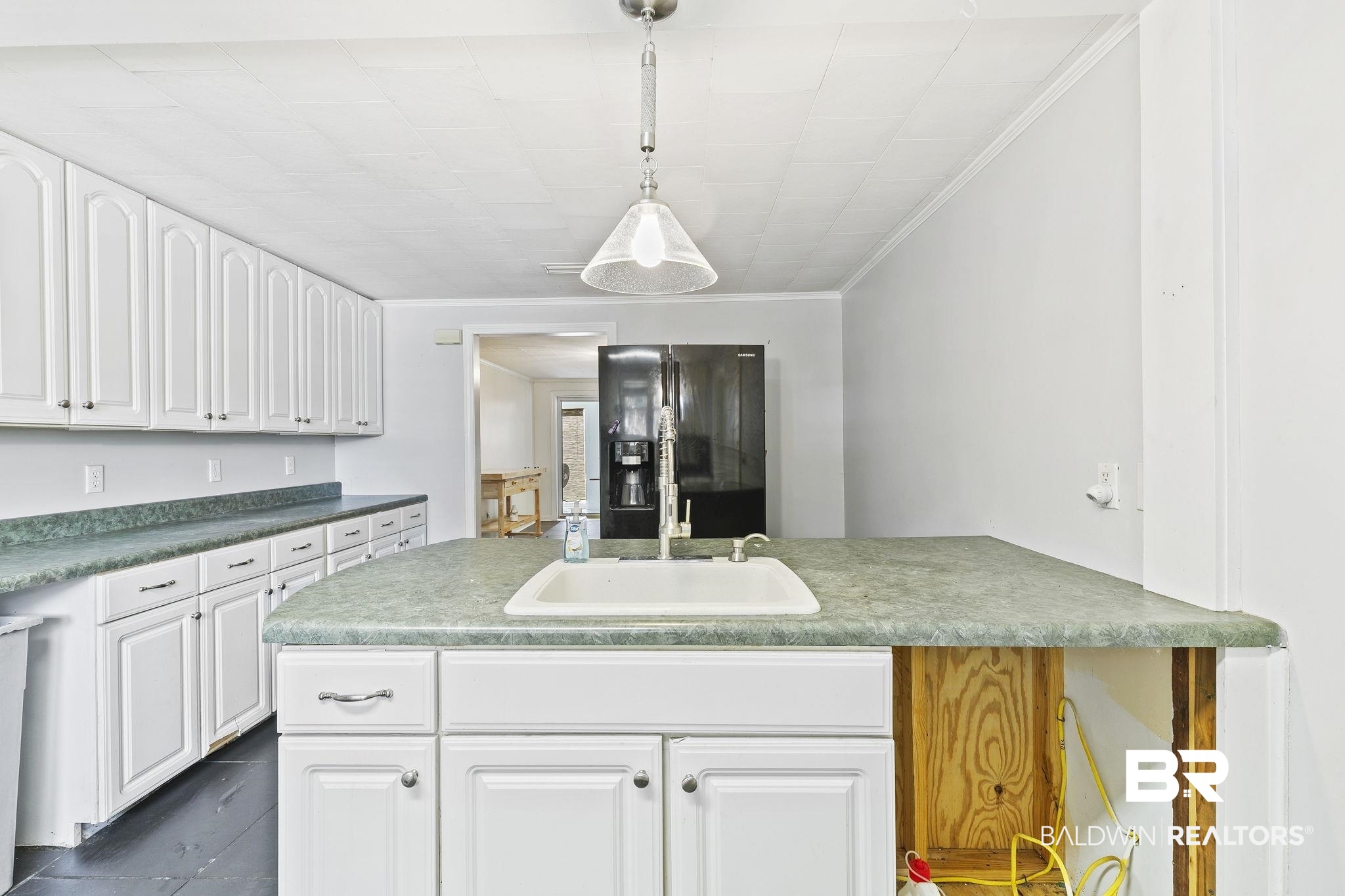 316 West Orchid Avenue Foley, AL 36535 - Photo 28 of 38 Kitchen featuring black refrigerator with ice dispenser, white cabinetry, crown molding, a peninsula, and hanging light fixtures