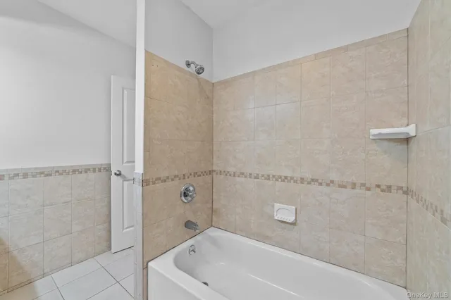 a bathroom with a bathtub and shower