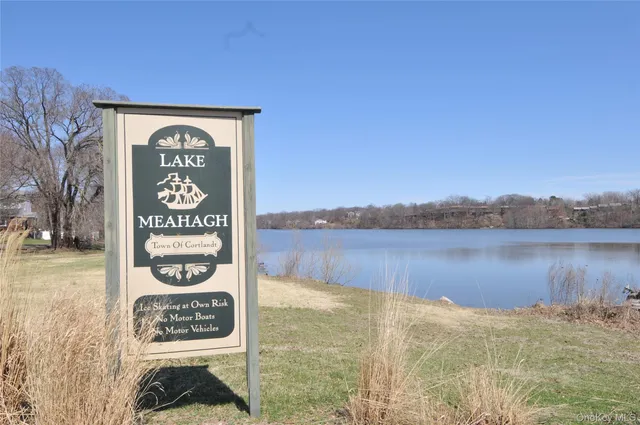 a sign board with a lake view
