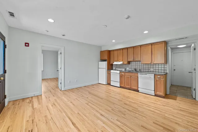a view of kitchen with granite countertop cabinets and wooden floor