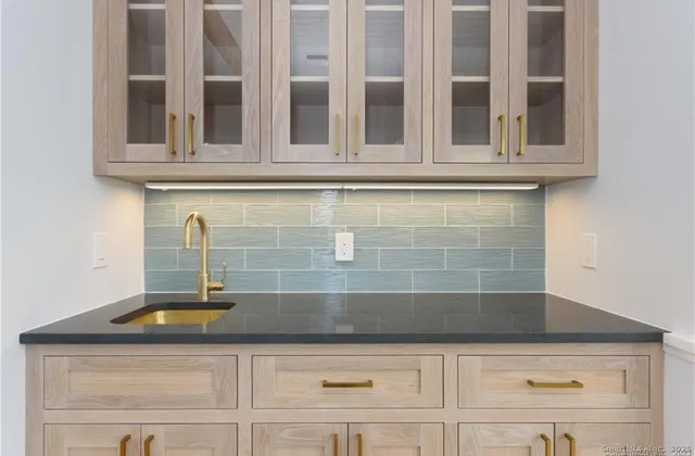 a kitchen with granite countertop cabinets