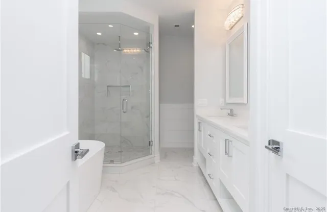 a bathroom with a double vanity sink toilet and shower