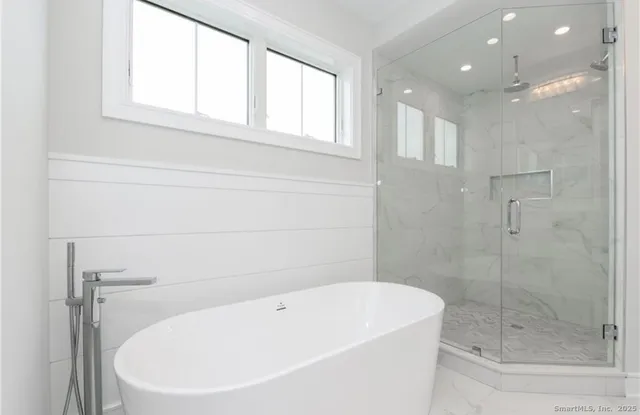 a white bath tub sitting next to a window