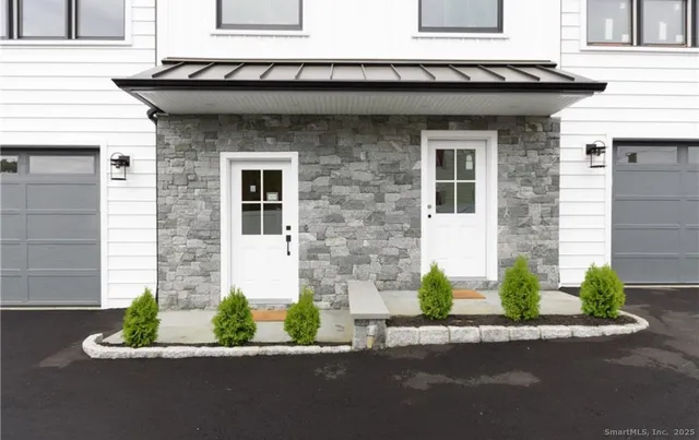 a front view of a house with a yard and a garage