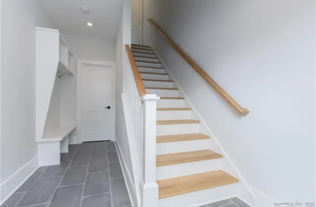 a view of entryway and hall with wooden floor