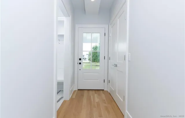 a view of a hallway with wooden floor