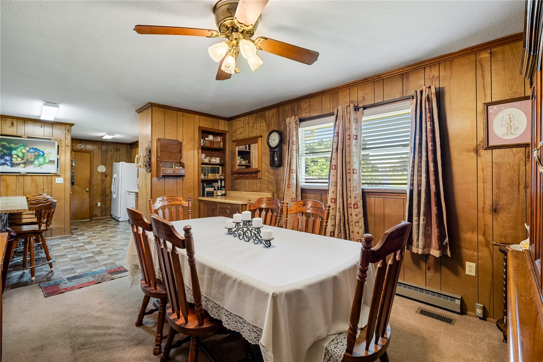 312 Edwards Drive Anderson, SC 29626 - Photo 13 of 44 A well-lit dining area featuring warm wood paneling and direct access to the kitchen.