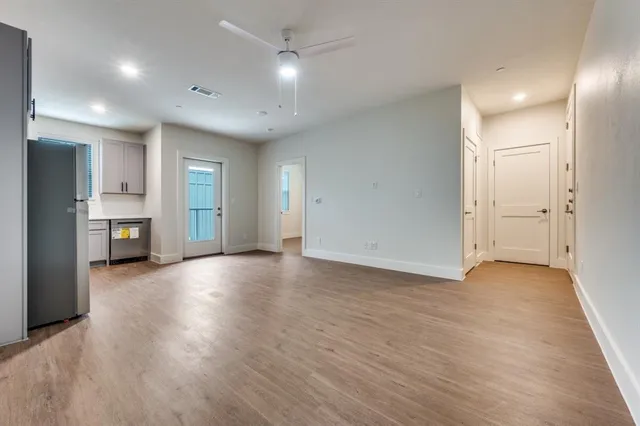 a view of a kitchen with a sink and a refrigerator