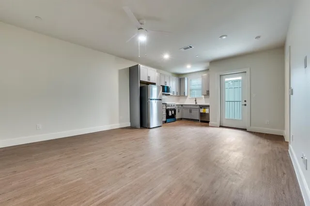 a view of kitchen with refrigerator stove microwave and cabinets