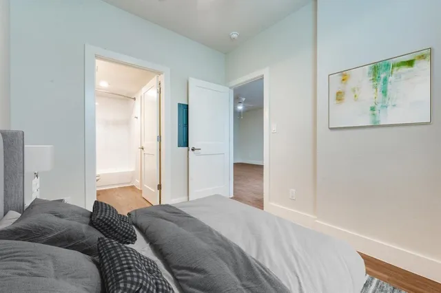 a bedroom with a bed and a painting on the wall