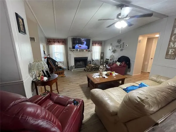 a living room with fireplace furniture and a flat screen tv