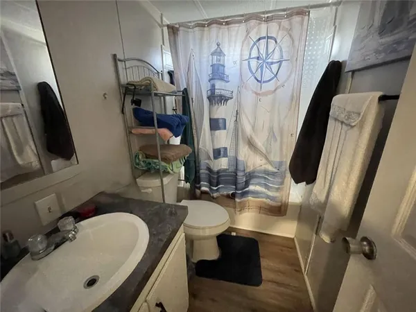 a bathroom with a sink toilet and shower