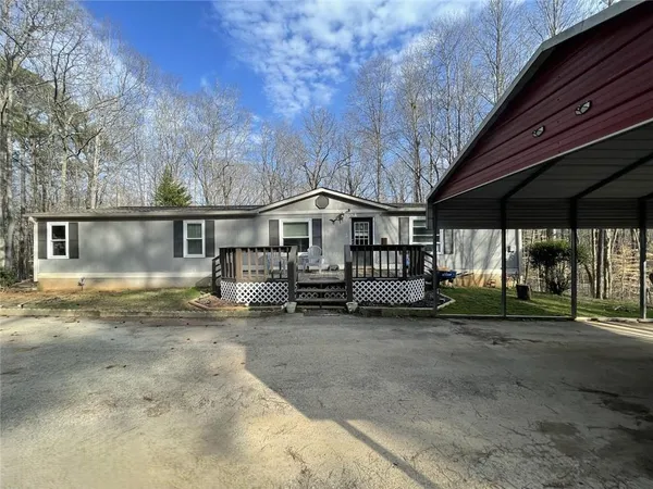 a view of a house with a yard and roof