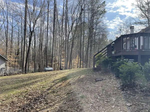 a view of a house with a yard and tree s
