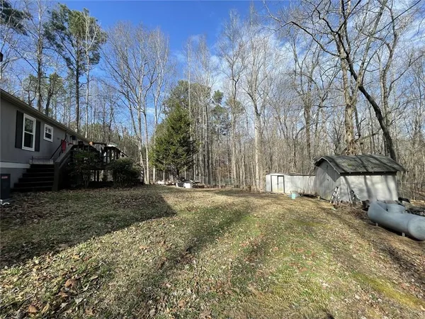 a view of a yard with cars