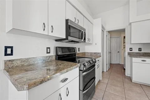 a kitchen with stainless steel appliances granite countertop a sink and a stove