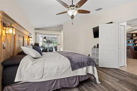 a bedroom with a bed and wooden floor