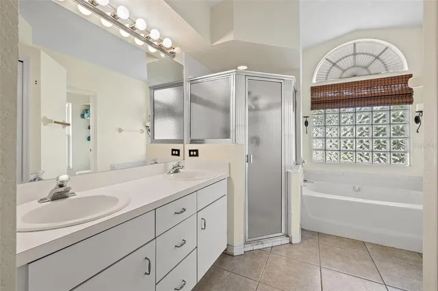 a bathroom with a sink a vanity a mirror and a bathtub