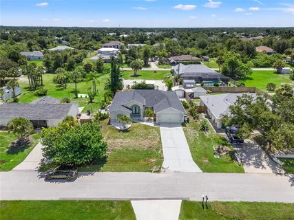 a dining room with stainless steel appliances kitchen island granite countertop a table and chairs