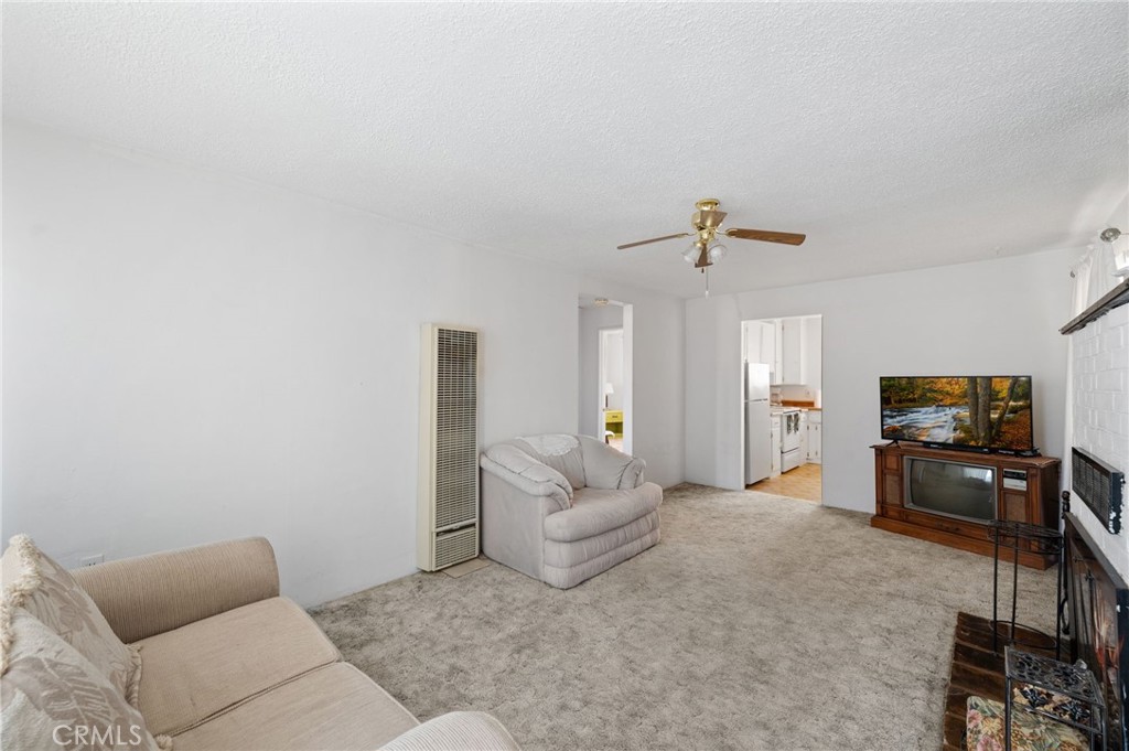 28074 Waterman Road Barstow, CA 92311 - Photo 11 of 25 a living room with furniture and a flat screen tv