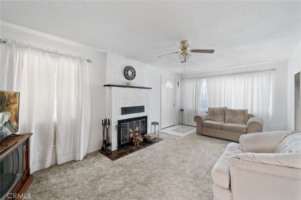 28074 Waterman Road Barstow, CA 92311 - Photo 12 of 25 a living room with furniture and a fireplace