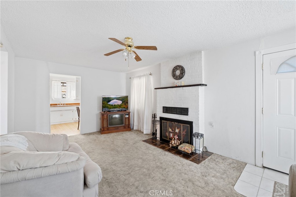 28074 Waterman Road Barstow, CA 92311 - Photo 13 of 25 a living room with furniture and a fireplace