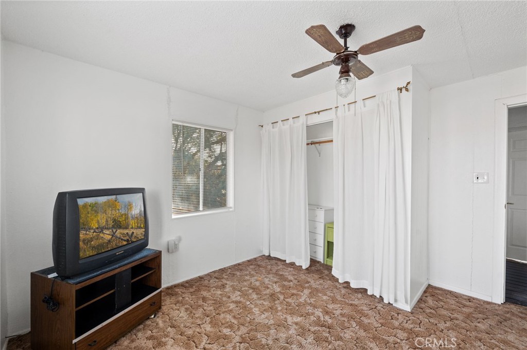 28074 Waterman Road Barstow, CA 92311 - Photo 20 of 25 a living room with furniture and a flat screen tv