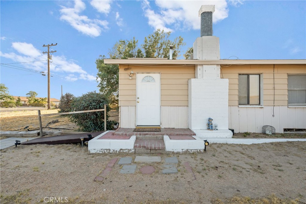 28074 Waterman Road Barstow, CA 92311 - Photo 9 of 25 a backyard of a house with sofas table and chairs