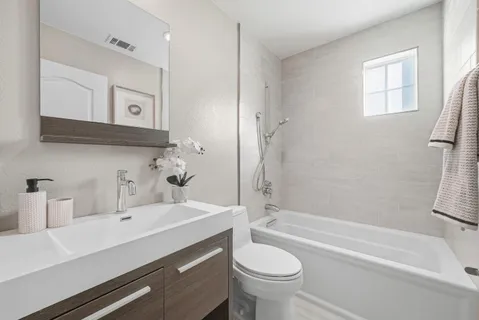 a bathroom with a sink a toilet and bathtub