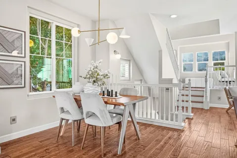 a view of a dining room with furniture window and wooden floor