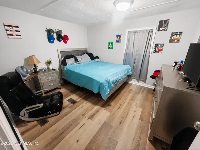 a bedroom with furniture and a flat screen tv