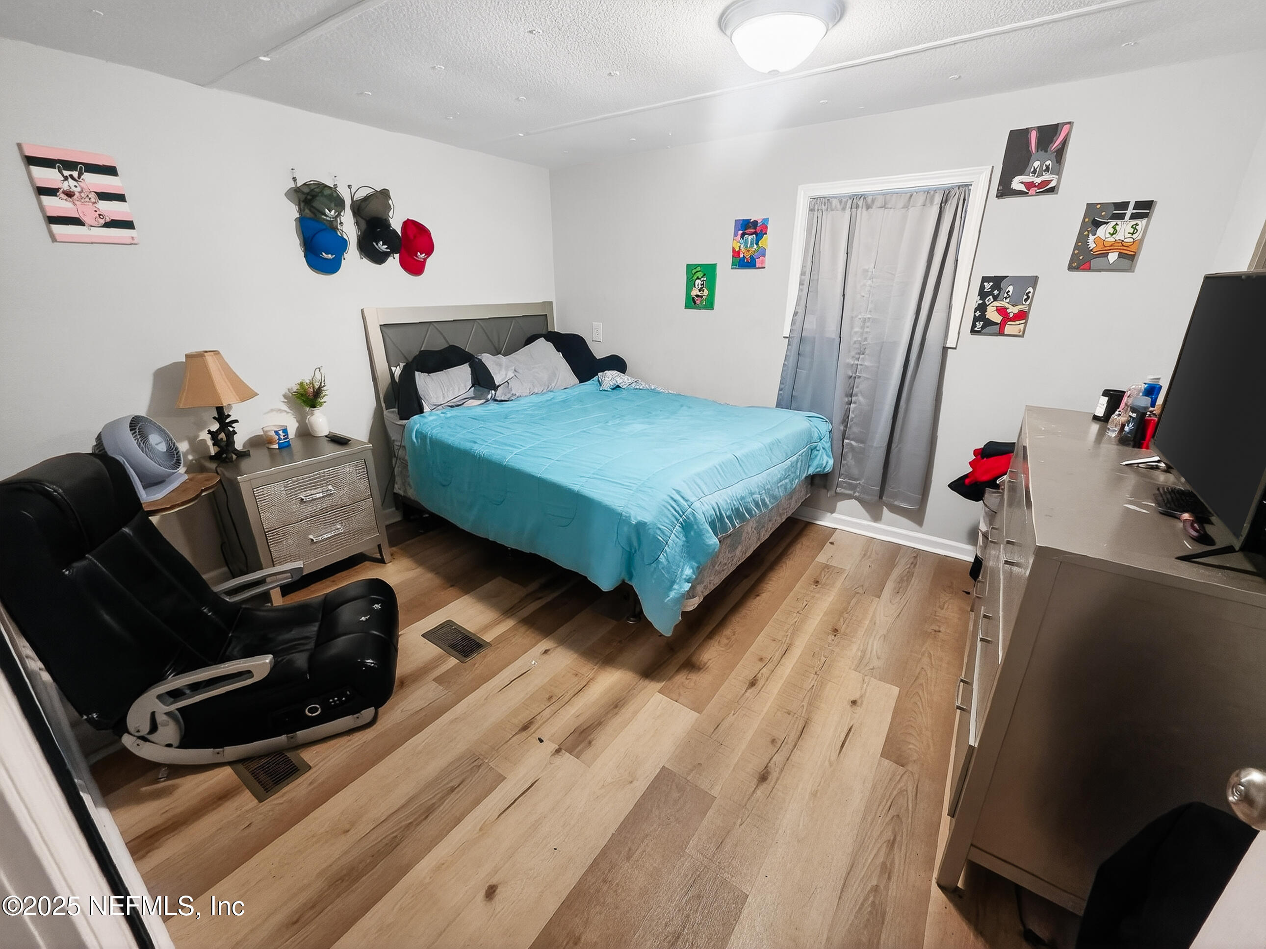 9332 Cedar Road Macclenny, FL 32063 - Photo 12 of 35 a bedroom with furniture and a flat screen tv