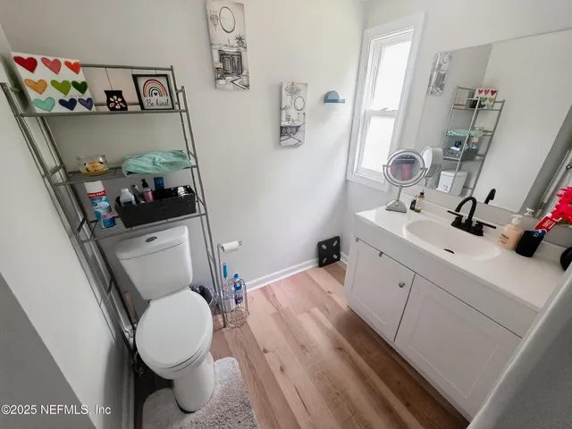 a bathroom with a sink toilet vanity and tub