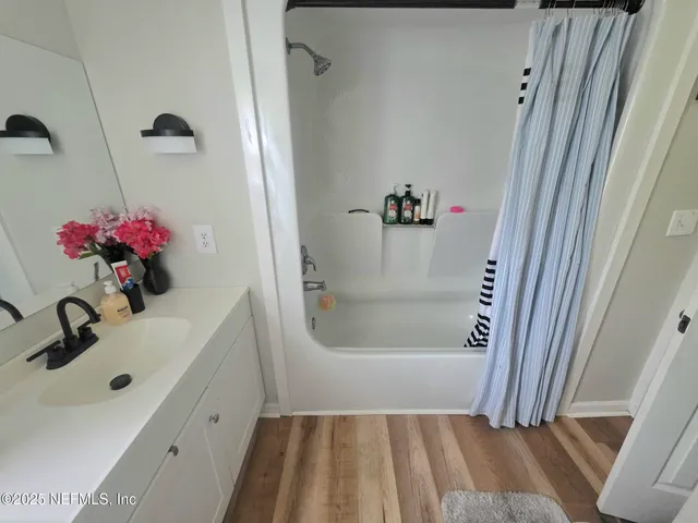 a bathroom with a sink and shower